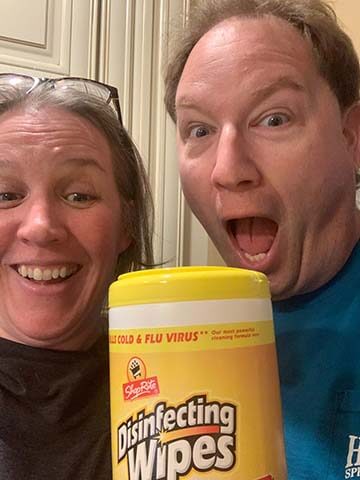 Two people happy to have disinfecting wipes